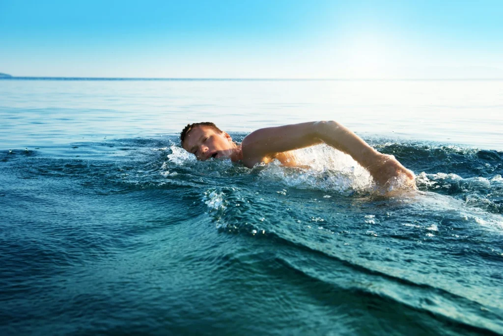 a man swiming in the ocean 2 How Long To Swim A Mile In The Ocean?